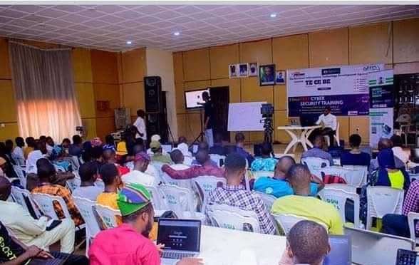 Trainees with laptops in a training hall